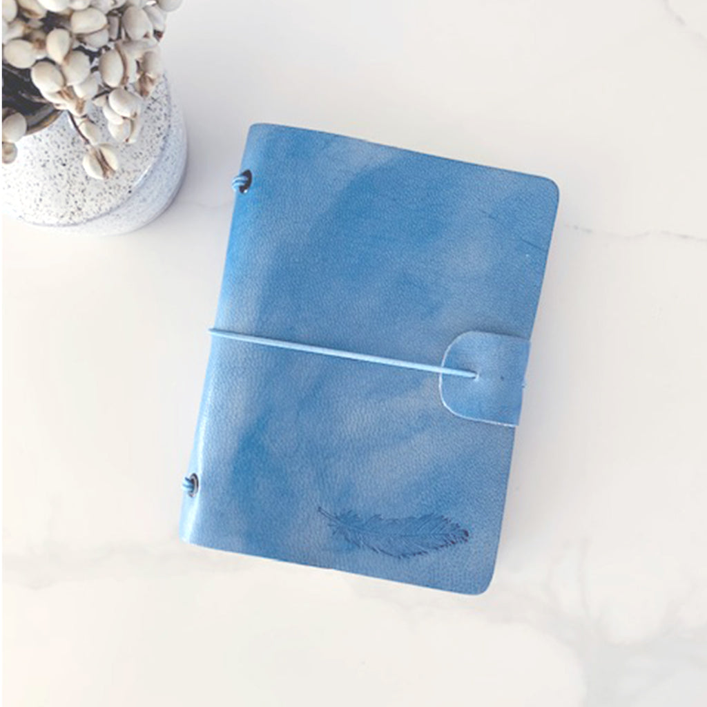 Blue leather journal with blank pages and hand embossed feather design